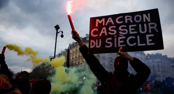 The protesters' sign reads: 'Macron, rioter of the century' (Image: