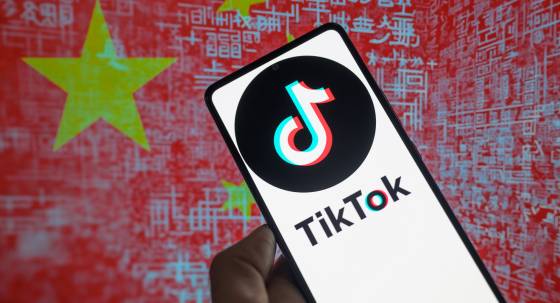 The TikTok logo on a smartphone against a graphic depicting the Chinese flag (Image: Jonathan Raa/SIPA USA)