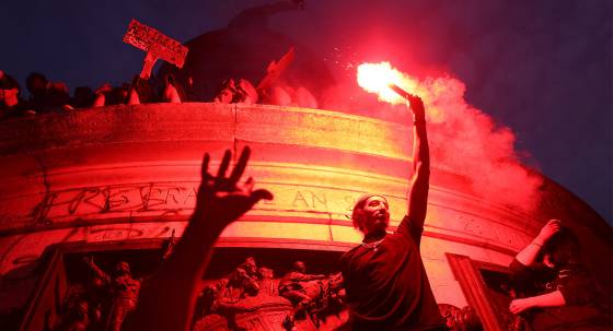 A demonstrator celebrating the victory of the New Popular Front in Paris, France (Image: AAP/Christophe Michel)