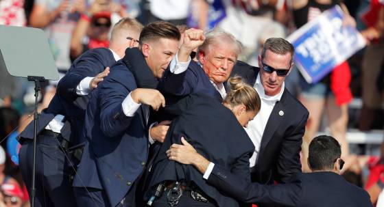 Donald Trump is rushed off stage by secret service after being shot at (Image: EPA/David Maxwell)