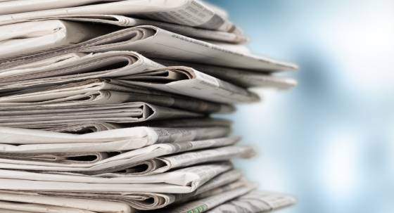 Pile of newspapers on white background