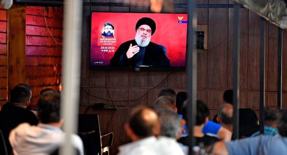 People watch Hezbollah Secretary-General Hassan Nasrallah delivering a televised speech at a coffee shop in Beirut (Image: EPA/ABBAS SALMAN)